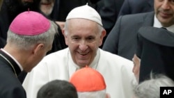 Pope Francis talks to prelates during an audience with participants of a pilgrimage of the Italian-Albanian diocese of Lungro, in the Pope Paul VI hall at the Vatican, May 25, 2019.