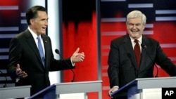 Republican presidential candidates Mitt Romney, left, Newt Gingrich, right, during the Republican debate, in Des Moines, Iowa, December 10, 2011.