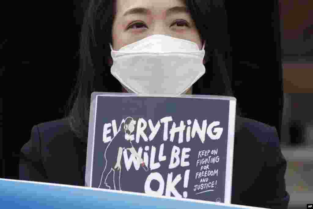 A South Korean lawmaker Choi Hye Young holds a sign during a news conference supporting Myanmar&#39;s democracy in front of the Myanmar Embassy in Seoul.