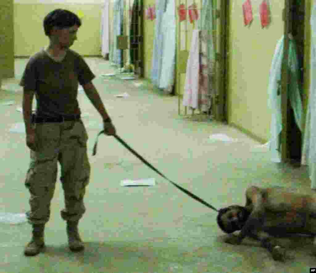 This is image obtained by The Associated Press shows Pfc. Lynndie England holding a leash attached to a detainee in late 2003 at the Abu Ghraib prison in Baghdad, Iraq.