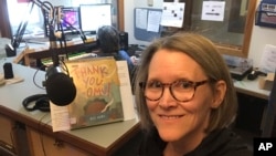In this April 2, 2020, photo provided by librarian Claudia Haines, she poses for the selfie while preparing to read stories on the air at local radio station KBBI in Homer, Alaska. (Claudia Haines via AP)