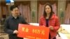 Chinese tennis star Li Na accepts a check from Hubei Communist Party chief Li Hongzhong Tuesday, January 28, 2014 following her weekend championship win at the 2014 Australian Open.