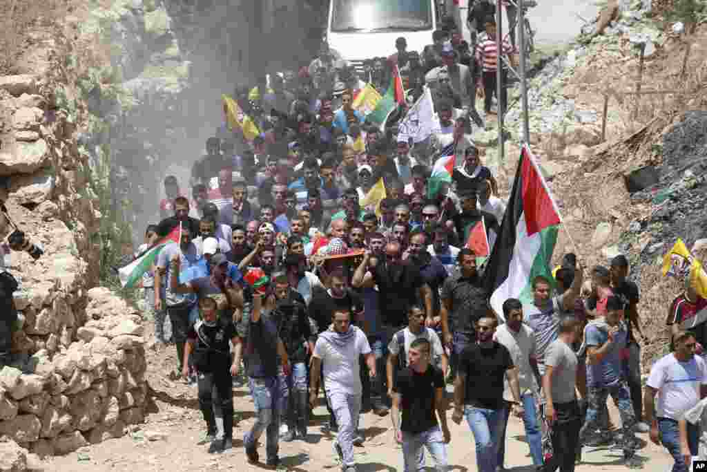 Mourners carry the body of Muhey al-Tabakhi, 12, during his funeral in the West Bank town of Al-Ram, near Jerusalem.&nbsp;A Palestinian hospital official said the boy was killed after clashes erupted between Israeli forces and protesters in the West Bank.