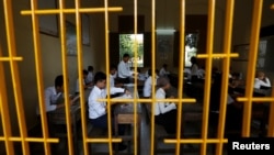 FILE - Students sit for the final examinations at the Sisowath High School in central Phnom Penh, Cambodia, Aug. 22, 2016. A new report shows Cambodian children with disabilities are twice as likely to be out of school compared to children without disabilities.