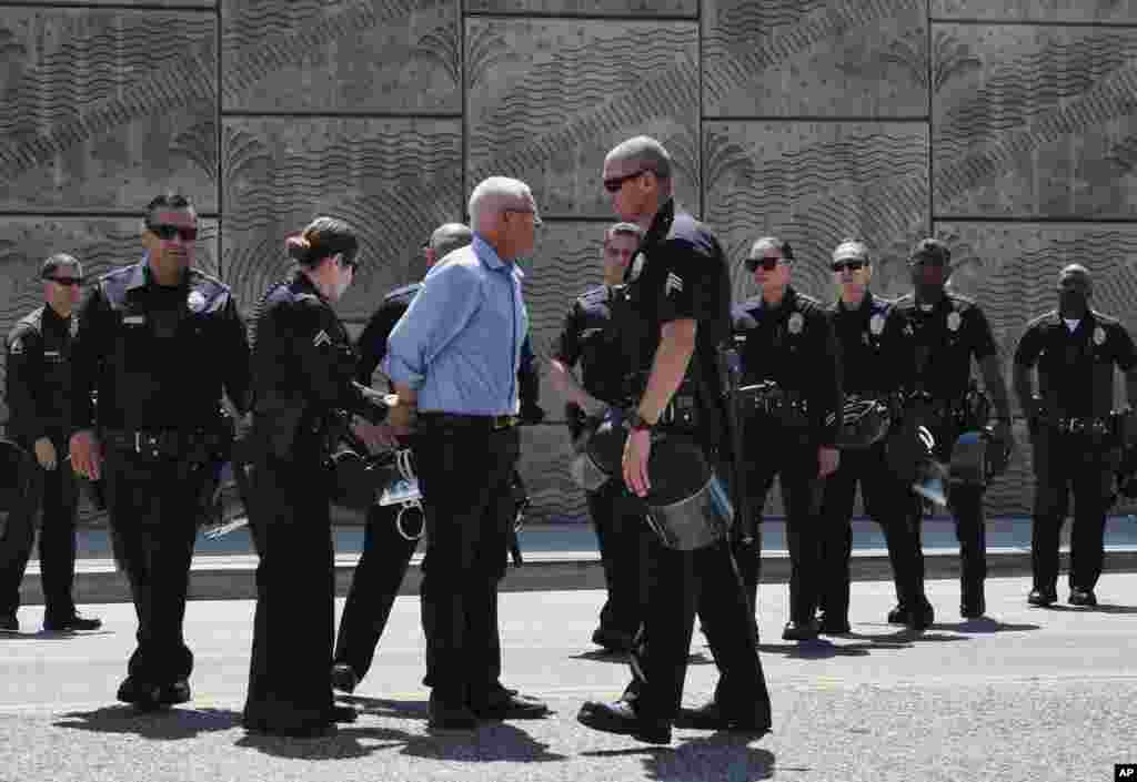Los Angeles City Councilman Mike Bonin is handcuffed after being arrested in front of the Immigration and Customs Enforcement facility in downtown Los Angeles, California, July 2, 2018.