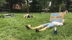 A protester holds a sign opposing in-person classes Monday, August 17, 2020, at a "die-in" at Georgia Tech in Atlanta. (AP Photo/Jeff Amy)