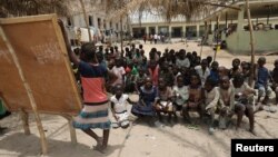 Children gather at a makeshift school at the IDPs Abagena camp in Benue, Nigeria, April 11, 2018.