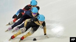 FILE - Japan's Kei Saito leads in front of Thomas Insuk Hong, of the United States, and China's Lu Xiucheng as they compete in the men's 1000 meter short track speed skating competition in Innsbruck, Austria.