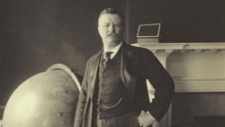 President Theodore Roosevelt stands by a globe in this 1905 photograph