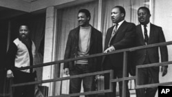 FILE - The Rev. Martin Luther King Jr. stands with other civil rights leaders on the balcony of the Lorraine Motel in Memphis, Tenn., a day before he was assassinated at approximately the same place, April 3, 1968.