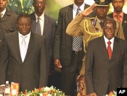 PM Morgan Tsvangirai (L) and President Robert Mugabe (R) are pictured at Zimbabwe International Investment Conference in Harare, 09 Jul 2009