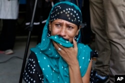 A relative of a an Indian man convicted for the 2002 Gujarat riots cries after the court announced the lengths of the sentences in Ahmadabad, India on June 17, 2016.