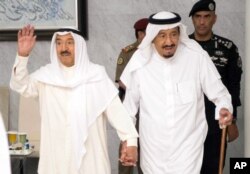 In this Tuesday, June 6, 2017 photo released by Saudi Press Agency, SPA, Saudi King Salman bin Abdulaziz Al Saud, right, receives Kuwait's Emir Sheikh Jaber al-Ahmad al-Sabah in Jiddah, Saudi Arabia.