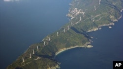 Wind turbines stand along the 50-kilometer (31-mile)-long Sadamisaki Peninsula in Ehime Prefecture, western Japan, which will now become more important as Japan shuts down its last operating nuclear power reactor, December 2, 2011 (file photo).