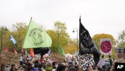 Climate activists march through the streets of Glasgow, Scotland, Friday, Nov. 5, 2021 which is the host city of the COP26 U.N. Climate Summit. The protest was taking place as leaders and activists from around the world were gathering in Scotland's bigges