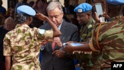 United Nations Secretary-General Antonio Guterres, 2nd left, gives a medal to a U.N. soldier during the ceremony of Peacekeepers' Day at the operating base of MINUSMA (The United Nations Multidimensional Integrated Stabilization Mission in Mali) in Bamako, May 29, 2018.