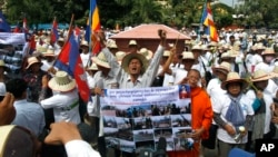 Cambodians shout slogans in front of the National Assembly to mark the World Habitat Day, in Phnom Penh, Cambodia, Monday, Oct. 6, 2014. 