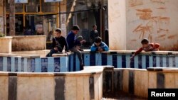 FILE - Children play in the town of Azaz, near the Syrian-Turkish border, March 2014. Syrian refugees in this border outpost were delighted to hear their home town of Azaz had been liberated from al-Qaida fighters who subjected them to a brutal regime.