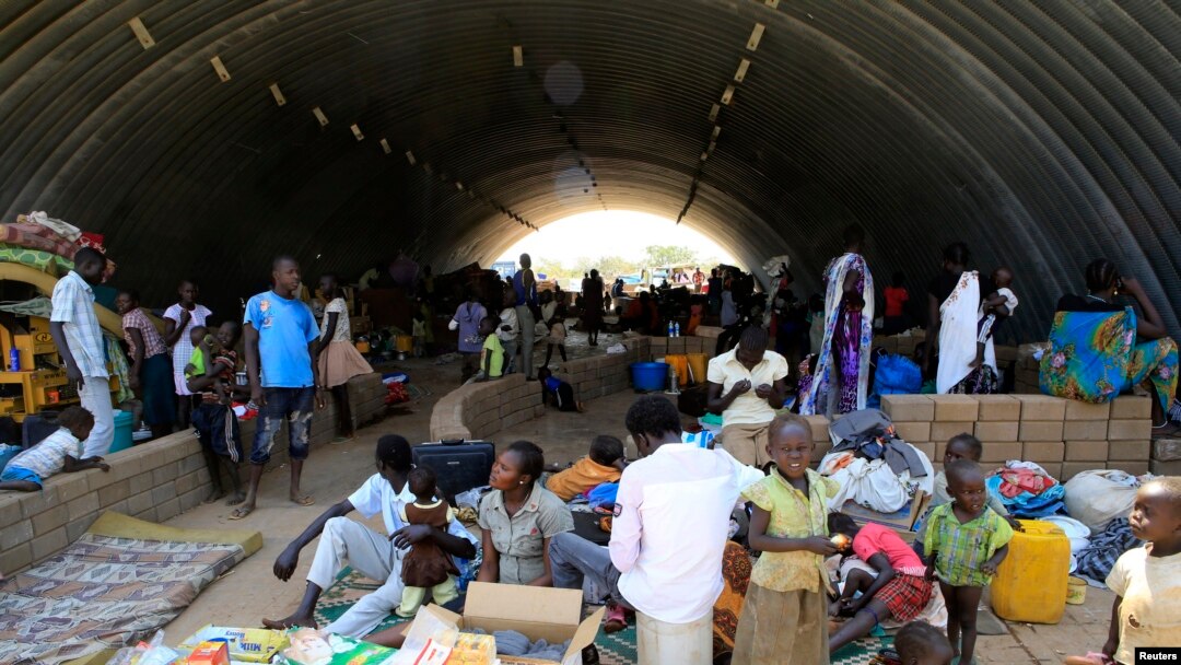 Families displaced by fighting in South Sudan camp in a warehouse inside the United Nations Mission in Sudan facility in Jabel, on the outskirts of Juba, Dec. 23, 2013.