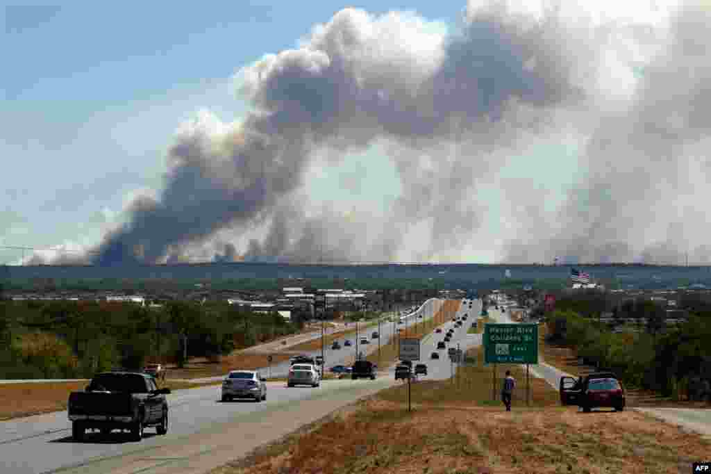 September 5: A series of large wildfires approaching Bastrop, Texas on Highway 71. (AP Photo/Erich Schlegel)