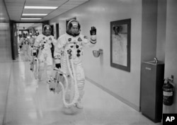 FILE - In this Dec. 21, 1968, file photo made available by NASA, Apollo 8 Commander Col. Frank Borman leads the way as he and fellow astronauts Command Module Pilot Capt. James A. Lovell Jr. and Lunar Module Pilot Maj. William A. Anders head to the launch pad at the Kennedy Space Center in Florida.