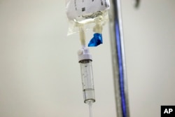 FILE - Chemotherapy drugs are administered to a patient at North Carolina Cancer Hospital in Chapel Hill, North Carolina, May 25, 2017. Health experts are stepping up warnings as more cardiac side effects of some breast cancer treatments come to light.