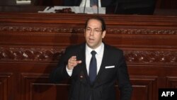 FILE - Tunisian Prime Minister Youssef Chahed addresses the parliament on the country's anti-corruption fight on July 20, 2017, in Tunis. 