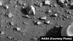 First image taken by Viking 1 on July 20, 1976 to show that the lander was upright with its foot planted firmly on the Martian soil.