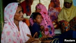 Shamsun Nahar (left), 60, a Rohingya widow who fled from Kha Maung Seik village of Myanmar to Bangladesh alone, whose 30-year-old son is missing, tells her story at Kutupalang Makeshift Camp in Cox’s Bazar, Bangladesh, Sept. 4, 2017.