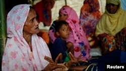 Shamsun Nahar (left), 60, a Rohingya widow who fled from Kha Maung Seik village of Myanmar to Bangladesh alone, whose 30-year-old son is missing, tells her story at Kutupalang Makeshift Camp in Cox’s Bazar, Bangladesh, Sept. 4, 2017.