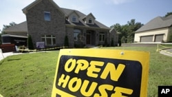 An open house sign is displayed in front of a new home being readied for sale in Little Rock, Arkansas, August 22, 2011.