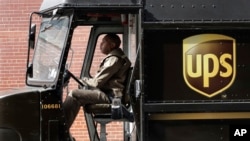 In this May 9, 2017, photo, a UPS driver takes his truck on a delivery route, in New York. 