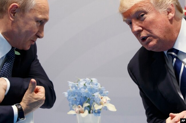 FILE -U.S. President Donald Trump (R) meets with Russian President Vladimir Putin at the G20 Summit in Hamburg, Germany, July 7, 2017.