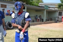 José Hernán, a catcher representing one of Havana’s three municipality teams, prepares to play at the 50th Anniversary Stadium in Cuba. He says baseball is to Cuba as football is to Brazil.