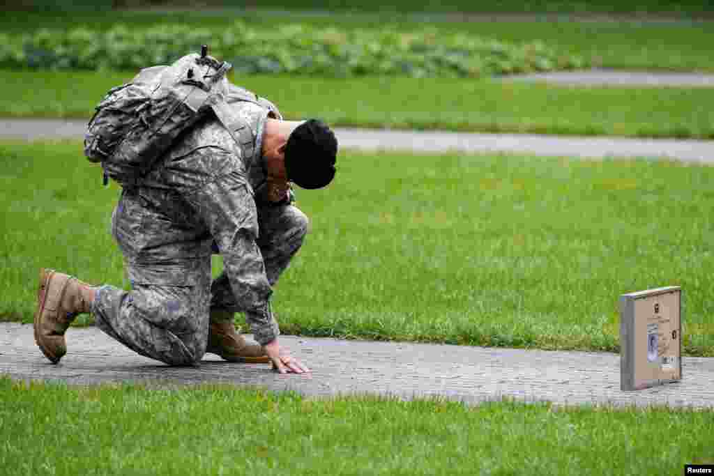 U.S. Army Reserve Sgt. Edwin Morales honors his cousin Ruben Correa during ceremonies marking the 17th anniversary of the September 11, 2001 attacks on the World Trade Center, at the National 9/11 Memorial and Museum in New York.