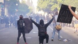 Demonstrators kneel in front of a line of police officers during a protest for the death of George Floyd, Monday, June 1, 2020, near the White House in Washington. Floyd died after being restrained by Minneapolis police officers. (AP Photo/Evan Vucci)