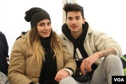 Christina and David Bshara wait in Presevo, Serbia, while traveling to Germany to reunite with their mother, Jan. 19, 2016. (P. Walter Wellman/VOA)
