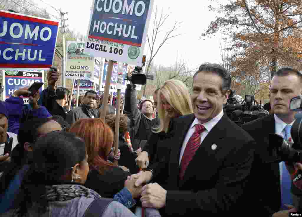 Democratic New York Governor Andrew Cuomo and his girlfriend Sandra Lee greet supporters after casting their ballots at the Presbyterian Church in the town of Mount Kisco, New York, Nov. 4, 2014.
