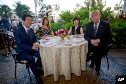 President Donald Trump, first lady Melania Trump, sit with Japanese Prime Minister Shinzo Abe and his wife Akie Abe for dinner Trump's private Mar-a-Lago club, April 17, 2018, in Palm Beach, Fla.