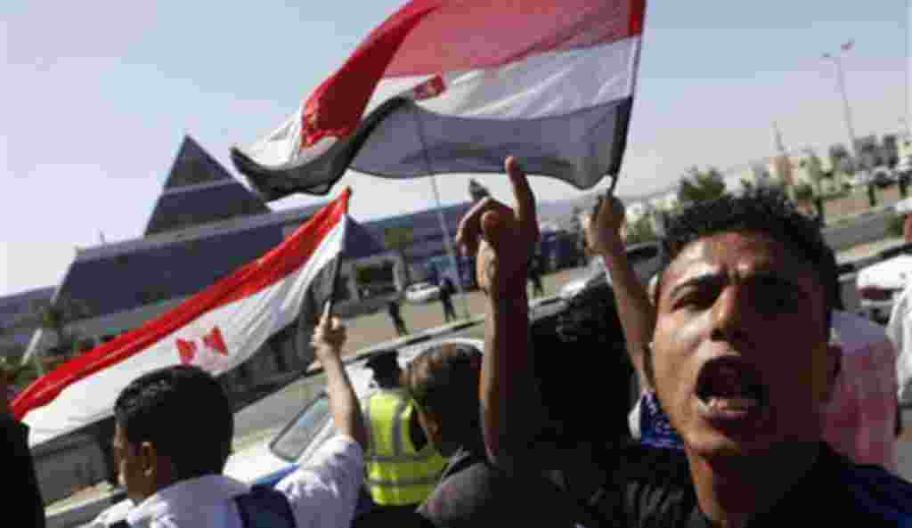 Egyptians shout anti-Mubarak slogans as they demonstrate in front of the hospital where former Egyptian President Hosni Mubarak, 82, is being treated in the Red Sea resort of Sharm el-Sheikh, Egypt, Wednesday, April 13, 2011.
