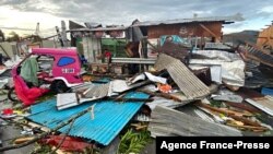 A resident salvages belongings Dec. 17, 2021, among debris caused by Super Typhoon Rai after the storm crossed over Surigao City, Philippines.