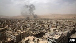 Picture shows smoke billowing from the Syrian rebel-held area of Douma, east of the capital Damascus, following a reported airstrike by Syrian government forces, Sept. 14, 2015