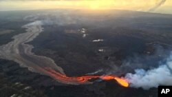 FILE - Sunrise is seen over the Kilauea volcano lower East Rift Zone in Hawaii in this July 17, 2018 photo provided by the U.S. Geological Survey.