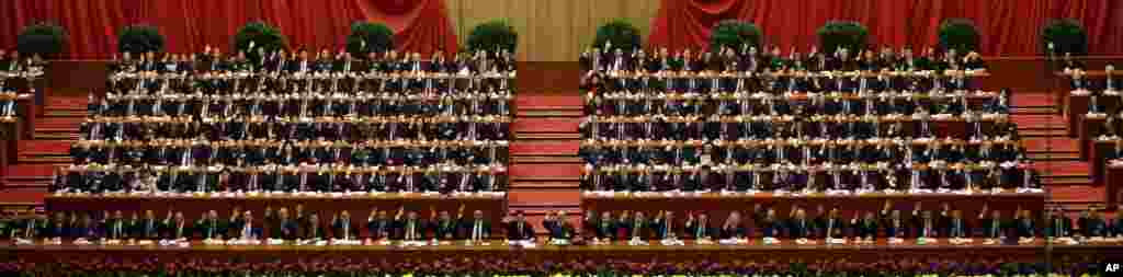 China's leaders raise their hands to show approval for a work report at the closing ceremony for the 18th Communist Party Congress, Beijing, November 14, 2012. 