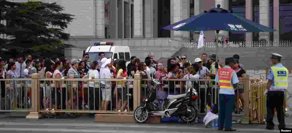Visitors line up for a security check to enter Tiananmen Square in Beijing, June 4, 2014. 