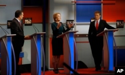 Carly Fiorina, center, speaks as Ted Cruz, left, and Rand Paul, right, listen during a Republican presidential debate at Milwaukee Theatre, in Milwaukee, Nov. 10, 2015.
