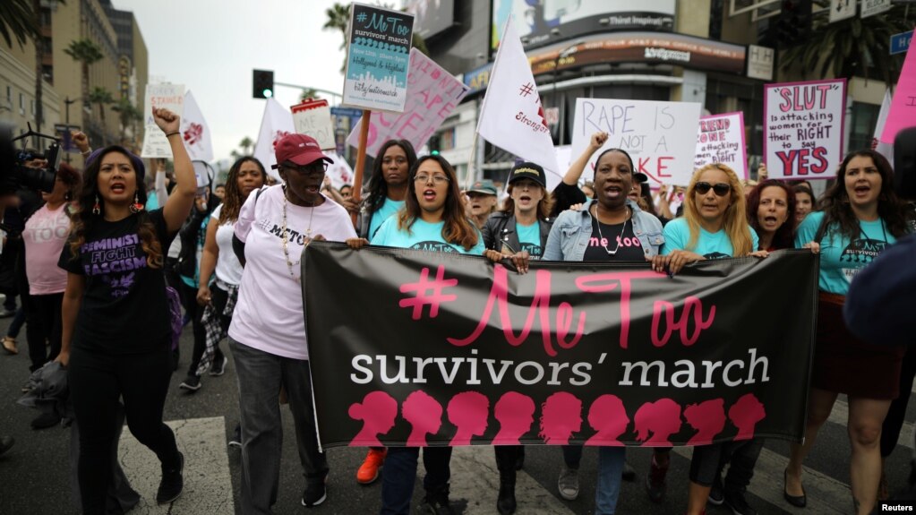 People participate in a protest march for survivors of sexual assault and their supporters in Hollywood, Los Angeles, California, Nov. 12, 2017.