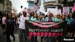 People participate in a protest march for survivors of sexual assault and their supporters in Hollywood, Los Angeles, California, Nov. 12, 2017.