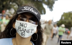 An activist takes part in a rally held the day before the start of the Paris Climate Change Conference (COP21), in San Jose, Costa Rica, Nov. 29, 2015.