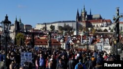 Tourists walk across the medieval Charles Bridge in Prague, Czech Republic, November 7, 2019. (REUTERS/David W Cerny)